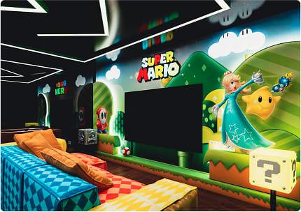 Super Mario home theater room with wall murals, cozy geometric sofas, and cinematic lighting setup.